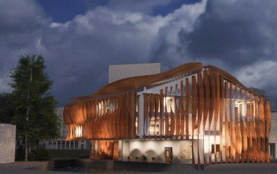 Night render of Maison Peplum, Brentford: curved timber fins glow from within over a former warehouse, beneath a dark cloudy sky.